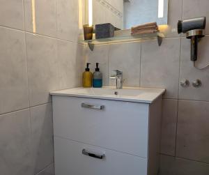 a bathroom with a sink with two bottles on it at Mitzi's Zauberblick in Landeck +40 photos