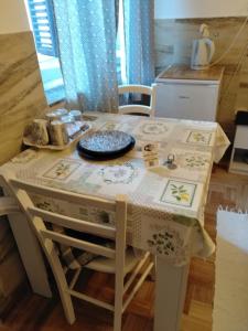a kitchen table with a table cloth on it at Two Room Eva in Pula