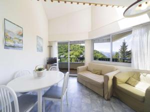 a living room with a couch and a table at Appartement avec mezzanine pour 4, vue sur Gourette - FR-1-400-49 in Gourette