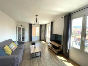 a living room with a couch and a table at VERLAINE House in Menton