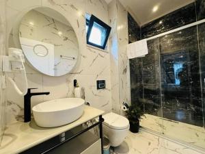 a bathroom with a sink and a toilet and a mirror at Eco villa in Quba +1 photo