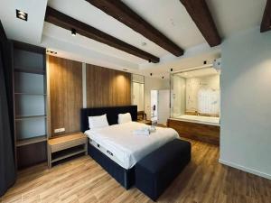 a bedroom with a large bed and a large mirror at Eco villa in Quba