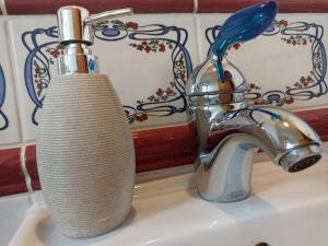 a bathroom sink with a toothbrush and a faucet at Chalupa Beliankovo Ždiar in Ždiar +24 photos