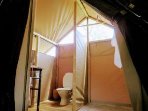 a small bathroom with a toilet in a tent at Bundox Explorer Camp in Hoedspruit +61 photos