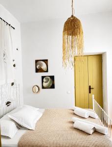 a bedroom with a bed with a yellow door at Lemonia House in Vívlos
