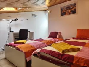 a bedroom with two beds and a desk with a lamp at North Wind House in Peniche +47 photos