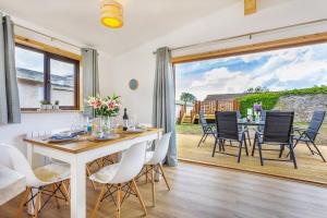 a dining room with a table and chairs at L54 - Sunny Corner in Truro