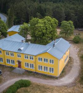 a large yellow house with a blue roof at Võhma Külamaja, room nr 8 in Võhma