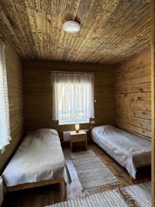 a room with two beds and a window at Võhma Külamaja, room nr 8 in Võhma