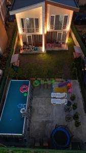 an overhead view of a pool with chairs and a house at Apartment IMERI in Ureki