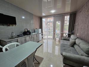 a living room with a couch and a table at Apartment IMERI in Ureki
