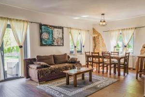 a living room with a couch and a table at Green Garden Plitvice lakes in Plitvica Selo