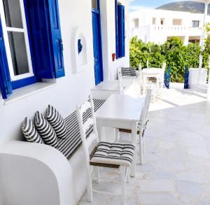 a white table and chairs on a patio at Lemonia House in Vívlos