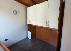a room with white cabinets and a wooden floor at Casa Mango in Stresa