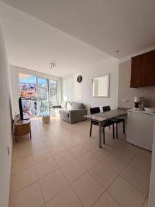 a kitchen and living room with a table and a couch at relax by the sea in Puerto de Santiago