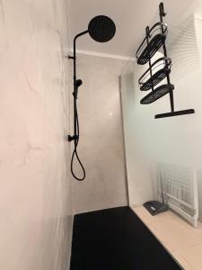 a shower in a room with a black floor at relax by the sea in Puerto de Santiago