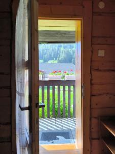 a door to a porch with a view of a yard at Privát Evi 166 in Nižná Boca