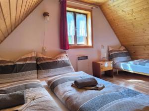 a bedroom with two beds in a attic at Privát Evi 166 in Nižná Boca