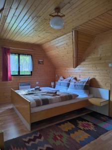 a bedroom with a large bed in a wooden room at Privát Evi 166 in Nižná Boca +13 photos