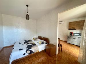 a bedroom with a bed and a kitchen at Hotel Kobuleti Garden in Kobuleti
