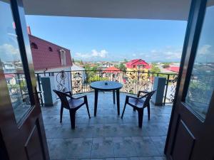 a balcony with a table and chairs and a view at Hotel Kobuleti Garden in Kobuleti +17 photos