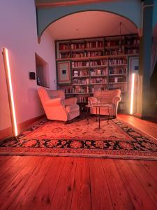 a living room with two chairs and a table at Cour De Berlin in Fürstenberg +64 photos