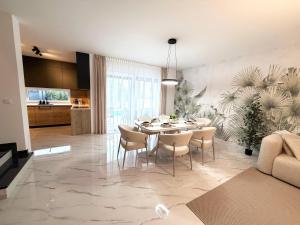 a dining room with a table and chairs in a living room at Luxury Villa Rubi Vir - private pool in Vir