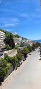 a street with cars parked on the side of the road at Bascarsija in Ulcinj