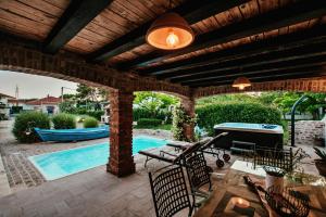 a patio with a pool and a pool table at Villa Romantika Dalmacija in Nin