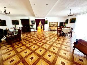 a living room with a wooden floor and a dining room at Leśna Ostoja in Górniki