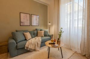 a living room with a blue couch and a table at Deluxe Flat Empoli GVARO in Empoli +15 photos