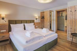 a bedroom with a large bed with white sheets and pillows at Apartment Gerlos 183 in Gerlos +29 photos