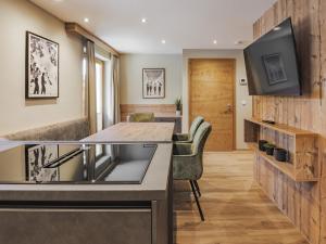 a kitchen with a counter and a tv on a wall at Apartment Gerlos 183 in Gerlos