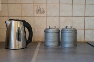 two coffee pots are sitting on a kitchen counter at Agios Ioannis Cozy Houses With Private Pool in Tigaki