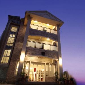 a tall building with lights on it at night at He Sen B&B in Kenting