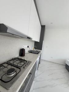 a kitchen with a stove and a counter top at Long Beach Royal Sun Elite Studio with Pool KKTC in Paralimni