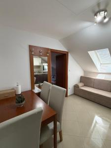 a living room with a table and a couch at Apartments Šoić in Samobor +96 photos