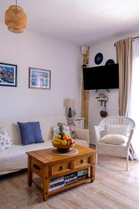 a living room with a table with a bowl of fruit on it at Apartment Stella in Vis