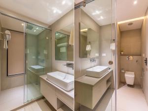 a bathroom with a sink and a shower and a toilet at Ranveer The Garden Resort in Haldwāni +55 photos