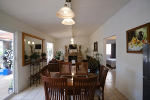 a dining room and living room with a table and chairs at Casa Los Agapandos in Valle de Bravo