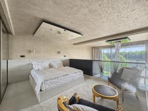 a large bedroom with a large bed and a chair at Eurovea Apartments in Bratislava