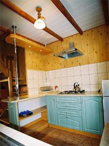 a kitchen with a blue cabinet and a sink at Leśna Polana in Baligród +15 photos