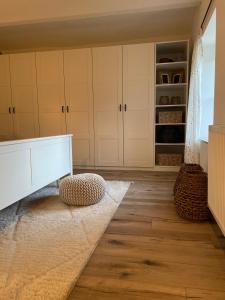 a kitchen with white cabinets and a rug at Chalupa jako domov in Kolín