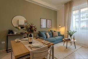 a living room with a blue couch and a table at Deluxe Flat Empoli GVARO in Empoli