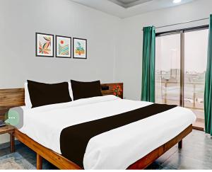 a bedroom with a large bed and a large window at Hotel sai laxmi residency in Lonavala
