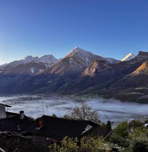 a view of a foggy valley in front of mountains at Belle vue des Alpes in Blavy