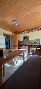 a kitchen with a wooden table in a room at Haus Sonnhof in Herzogau