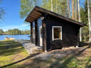 eine kleine Hütte am Ufer eines Sees in der Unterkunft StrandRo 2 in Hirvensalmi