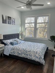 a bedroom with a bed and a ceiling fan at Modern & Spacious Apartment 15 Min to NYC Near MetLife & American Dream in Jersey City