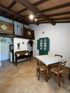 a living room with a table and chairs and a fireplace at Eclissi casa vacanza SOLE in Casalini